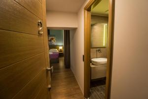 a small bathroom with a sink and a toilet and a mirror at 11City Rooms in Chania Town +53 photos