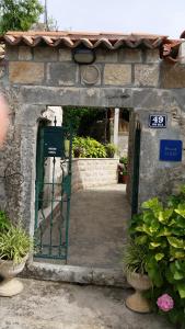 an entrance to a building with a green gate at Villa Violić in Zaton
