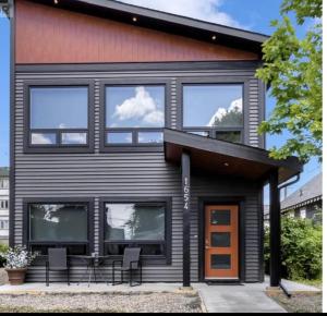 a house with black siding and windows on it at Pure Paradise in Prince George