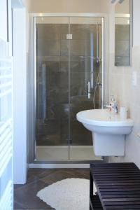 a bathroom with a shower and a white sink at Villa Lidia Teramo in Teramo