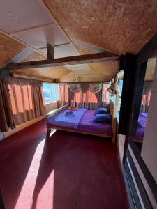 a bedroom with a bed in the middle of a room at Guesthouse Aprasidze in Mestia