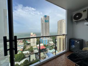 a room with a balcony with a view of the ocean at Condo in Malate in Manila