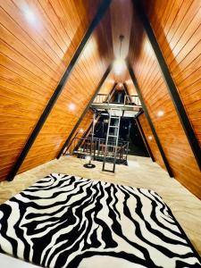 a zebra print rug in a room with a ceiling at Dreamers Den in Nuwara Eliya +17 photos