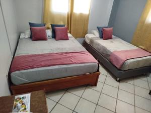 Postel nebo postele na pokoji v ubytování Hotel Los Rivera