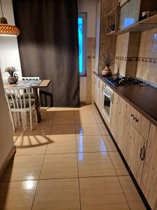 a kitchen with a table and a stove top oven at Boho Chic Apartament in Reghin