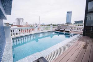 a swimming pool on the roof of a building at The ORCHID PREMIUM Hotel in Hue