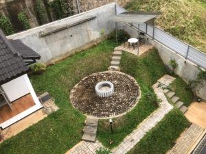 an aerial view of a garden with a fountain at Dwell Guesthouse Dago in Ciburial