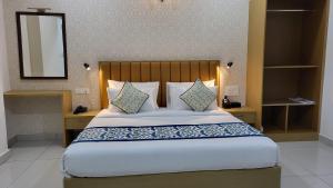 a bedroom with a large bed and a mirror at The Dritan in Bengaluru +26 photos