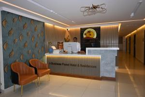 a hospital reception with orange chairs in a waiting room at The Dritan in Bengaluru
