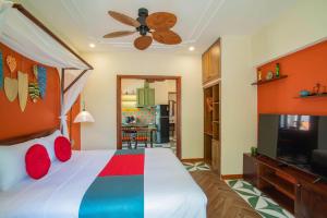 a bedroom with a bed and a ceiling fan at De'Hoian Holiday Villa in Hoi An