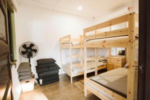 a room with two bunk beds and a fan at The Farm in Paya Rewak