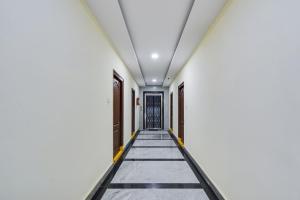 an empty corridor of a building with a door at Super Townhouse Hitech City Madhapur in Hyderabad