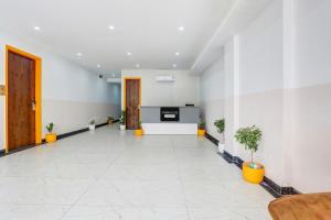 an empty lobby with plants in a building at Super Townhouse Sector 69 Gurgaon in Gurgaon