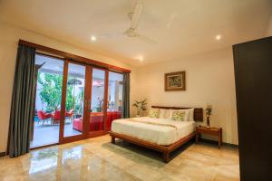 Un pat sau paturi într-o cameră la Rainbow Runner Villa by Great Bali Villas