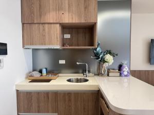 a kitchen with a sink and wooden cabinets at 留亦晚 in Toucheng