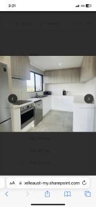 a kitchen with white counters and a stove top oven at LingaLonga in Busselton