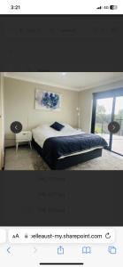 a bedroom with a bed and a window at LingaLonga in Busselton