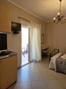 a kitchen with a door leading to a patio at Maraki in Thymonia Beach