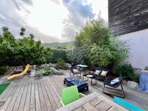 a patio with chairs and furniture on a wooden deck at Maison Lili 2 chambres - 4pers in Conca