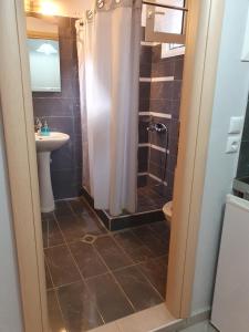 a bathroom with a shower and a sink at Maraki in Thymonia Beach +63 photos
