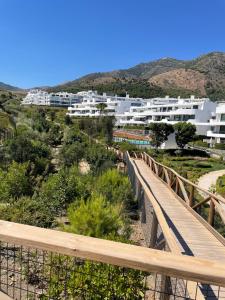 a bridge over a road with buildings in the background at Higuerón 5821 in Málaga