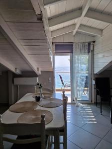 a dining room with a table and a view of the ocean at Maraki in Thymonia Beach