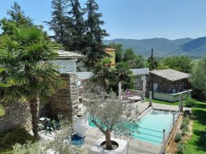 a villa with a swimming pool and a house at Alex's Guesthouse with a pool in Dhomátia