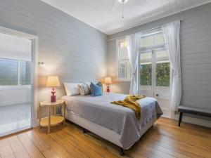 a bedroom with a bed and a window at Fig Tree House in Teven