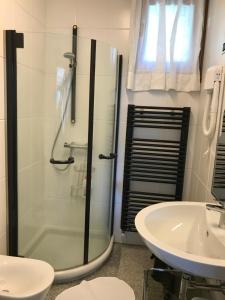 a bathroom with a glass shower and a sink at Mergozzo Beach in Mergozzo +41 photos