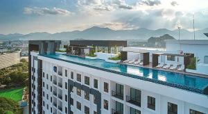 a hotel with a swimming pool on top of a building at Horizon Ipoh 8Pax 3R2B - Tropical Bird's Retreat in Ipoh