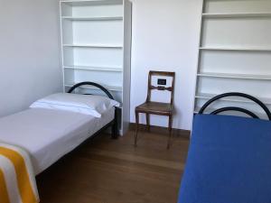 a small bedroom with a bed and a chair at Mergozzo Beach in Mergozzo +86 photos