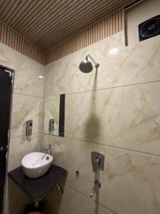 a bathroom with a sink and a shower at Hotel ILIKA in Bhopal +3 photos