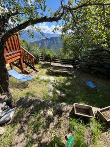 a bench and a picnic table under a tree at En pleine nature avec jardin in Les Blancs +22 photos