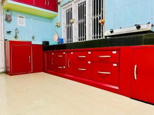 a red kitchen with red cabinets at Bloom homestay in Guwahati