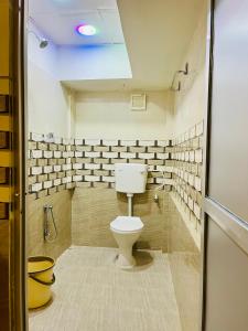 a bathroom with a toilet in a room at Bloom homestay in Guwahati