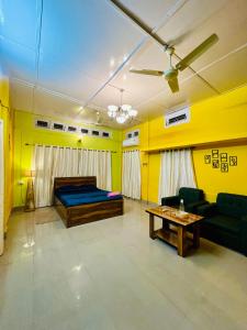 a living room with a bed and a table at Bloom homestay in Guwahati +18 photos