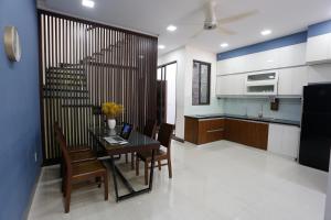 a kitchen and dining room with a table and chairs at Xanh Homestay in Da Nang