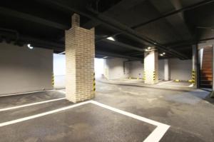 an empty parking garage with a brick pillar at Gwangalli Brown Dot Gwangalli Beach, Busan in Kwangan-dong +8 photos