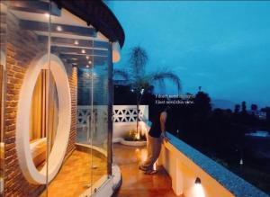 a person standing on the balcony of a house at Lahana Retreat in Katmandu International +11 photos