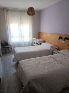 Posteľ alebo postele v izbe v ubytovaní Hostal Quiper
