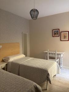 Posteľ alebo postele v izbe v ubytovaní Hostal Quiper