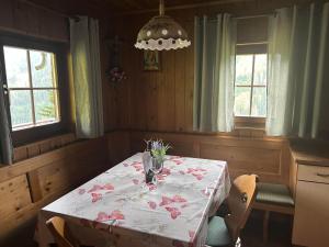 a dining room with a table with flowers on it at Lanzer Obheimat in Außervillgraten