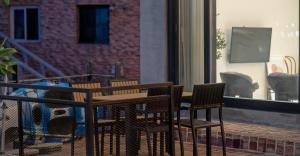 a wooden table and chairs on a patio at Gangneung Terramomum in Gangneung