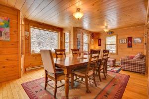 a dining room with a wooden table and chairs at Domaine Bonheura - Spa & Swimming Pool in Val-David +55 photos
