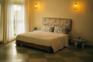 a bedroom with a large bed with a headboard at Asteya boutique stays in Varkala