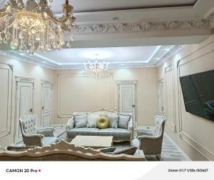 a living room with a couch and two chairs at Cozy Stay in Dushanbe