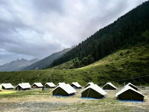 a bunch of tents in a field in a mountain at Glamping by Stay Pattern in Sonāmarg
