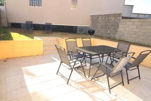 a table and chairs sitting on a patio at Maison - Proche RER - Jusqu'à 6 Personnes in Saint-Michel-sur-Orge +3 photos