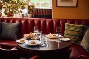 a table with plates of food and glasses of wine at The Sun Inn in Dedham +14 photos