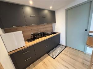 a kitchen with a counter with a coffee maker on it at Petit cocon cosy entre lac et montagnes in Malbuisson +4 photos